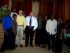 Bro. Eddie and Bro. Mickey standing with some of the singers and musicians of the church